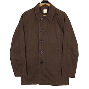 May include: A brown button-down jacket with a collared neckline. The jacket has a subtle vertical stripe pattern and four black buttons down the front. It features two front pockets and a tag on the collar. The jacket is hanging on a wooden hanger.