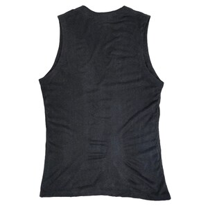 May include: A dark gray sleeveless tank top. The tank top has a scoop neck and a fitted silhouette. The fabric appears to be a soft, lightweight material. The garment is displayed against a white background.