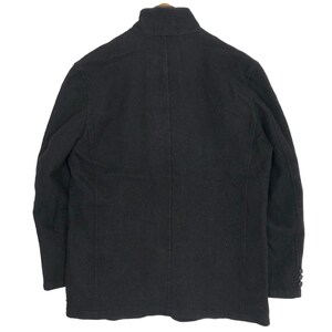 May include: A black wool blazer with a high collar and buttoned cuffs. The jacket has a tailored fit and a classic design, suitable for various occasions. The blazer is a versatile piece of outerwear.