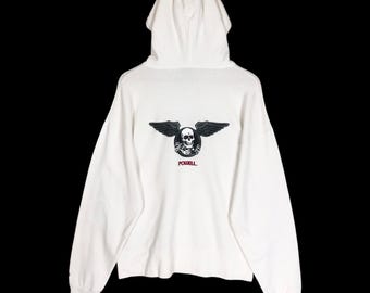 May include: White hooded sweatshirt with a black and gray skull and wing graphic on the back. The graphic includes the word "POWELL" in red. The sweatshirt has long sleeves and a drawstring hood.