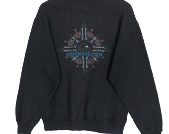 May include: A black Quiksilver sweatshirt with a graphic design on the back. The design features a compass rose with the Quiksilver logo in teal. The sweatshirt has long sleeves and a crew neck.