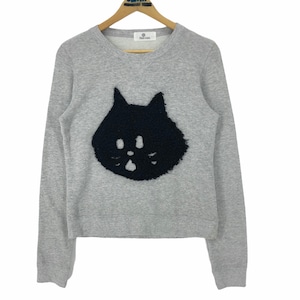 May include: A light gray sweatshirt with a black cat face applique. The cat face is made of a textured material and has two eye holes and a nose. The sweatshirt has long sleeves and a crew neck.