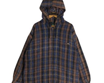 May include: A brown, blue, and tan plaid hooded sweatshirt with a half-zip closure. The sweatshirt has a small logo on the chest and a hood. The fabric appears to be a medium-weight material.