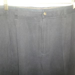 May include: A pair of black dress pants with a single button closure at the waist.