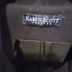 May include: A navy blue jacket with a label that reads "Karen Scott Petites".