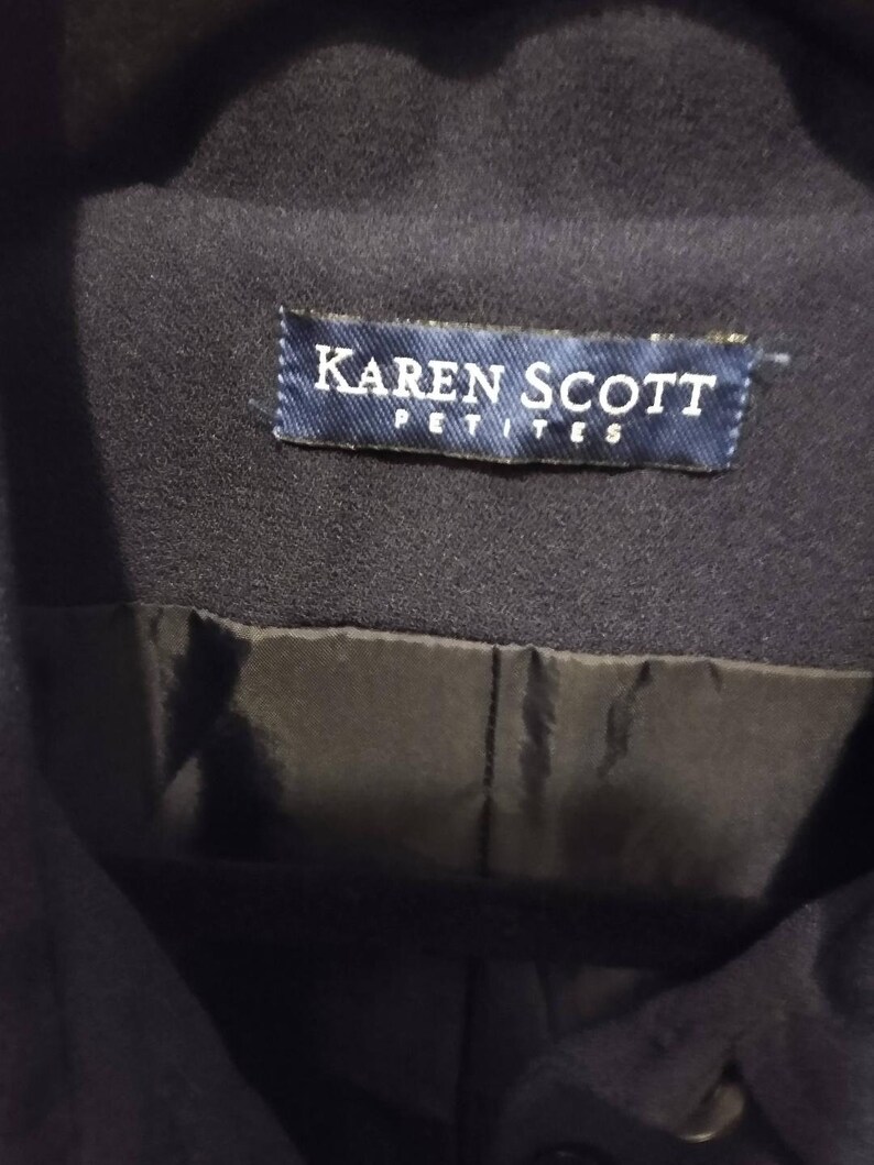 May include: A navy blue jacket with a label that reads "Karen Scott Petites".