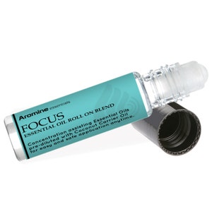 May include: Aromine essentials FOCUS Essential Oil Roll On Blend. A clear glass bottle with a turquoise label and black cap. The label reads "Concentration assisting Essential Oils pre-diluted with Coconut Carrier Oil for easy and safe application anytime."