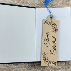 May include: A wooden bookmark with a floral design and the text "Think Celestial".