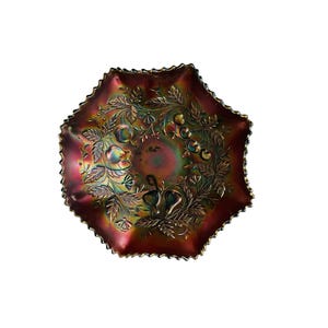 May include: A vintage iridescent glass bowl with a scalloped edge and a floral design. The bowl is in shades of red, purple, and green.