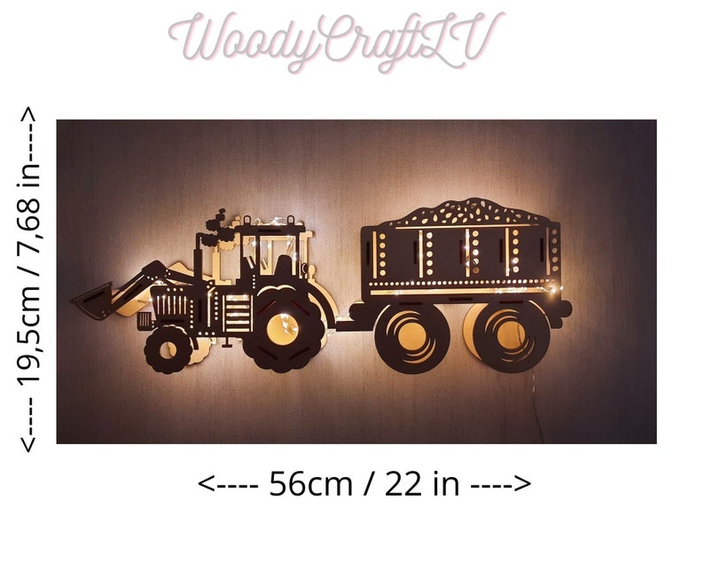 May include: A black wooden silhouette of a tractor with a trailer, illuminated with warm white lights. The tractor is 7.68 inches tall and 22 inches wide.