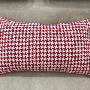 May include: Red and white patterned throw pillow with a houndstooth design.