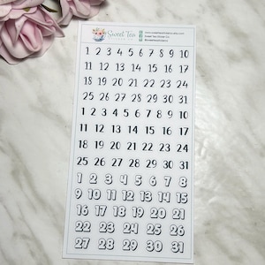 May include: A sheet of white paper with black numbers 1 through 31 printed in three rows. The numbers are in a simple, sans-serif font. The paper is surrounded by a white border.