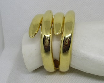 May include: Gold-toned metal bracelet with a coiled snake design.