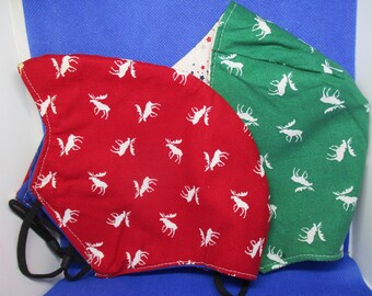 May include: Two fabric face masks with a moose print. One mask is red with white moose and the other is green with white moose.