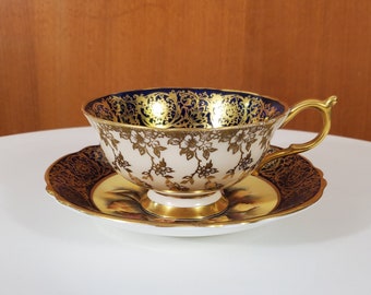 Paragon Floating Rose Footed Teacup and Saucer -  1949-52 - Rose Center, Cobalt Blue and Gold Band - Scalloped Edge