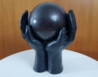 Iron (or steel or similar metal) Sculpture of Hands Holding a Bronze Sphere