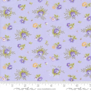 May include: A lavender fabric with a repeating pattern of small purple flowers and green leaves. The fabric is measured with a ruler that reads "moda" at the 2-inch mark and the 6-inch mark.
