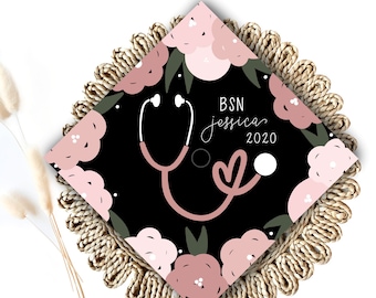 May include: A black graduation cap decorated with pink and green floral illustrations. The text "BSN Jessica 2020" is written on the cap.