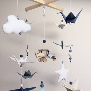 Origami baby mobile with airplane blue night, vintage style.