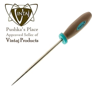 May include: A brown and turquoise metal awl with a wooden handle. The awl is packaged in a clear plastic bag with a brown and gold paper backing. The paper backing has the text "Vintaj Metal Awl" printed on it.