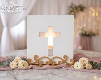 May include: A square white wooden plaque featuring a central cutout in the shape of a cross. The plaque is supported by a decorative gold-colored base with swirling scrollwork patterns. The text LEONARTS WOODEN DESIGN STUDIO is visible.