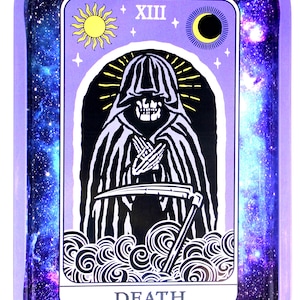 May include: A purple metal rolling tray with a galaxy print. The tray features a tarot card design with a black and white illustration of Death, the 13th card in the Major Arcana. The card has a yellow sun and crescent moon in the top corners.