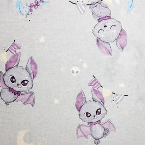 Close up of cartoon gray bats on premium cotton fabric