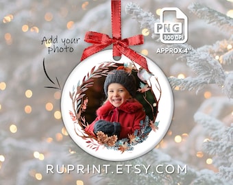 May include: A round Christmas ornament with a red ribbon and bow. The ornament features a watercolor design of a child in a red coat and a decorative wreath. The text "Add your photo" is visible, along with "APPROX. 4" and "RUPRINT.ETSY.COM".