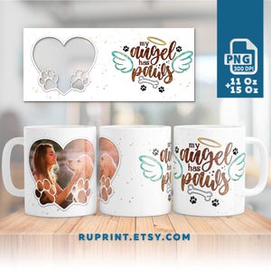 Può includere: Tazza in ceramica bianca con una cornice per foto a forma di cuore e il testo "my angel has paws" con un'aureola e ali. La tazza è da 11 oz o 15 oz.