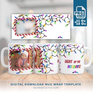 May include: White ceramic mugs with a Christmas lights design. One mug features a baby in a Santa hat. The phrase "LIGHT UP THE HOLIDAYS!" is printed on one mug. The image also includes a digital download mug wrap template.