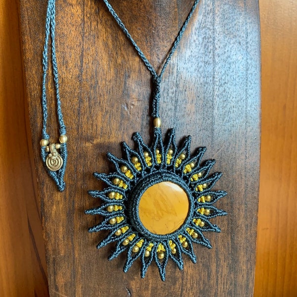 Handmade macrame necklace with large sun pendant with limonite set with waxed thread, golden hematite beads and brass charms