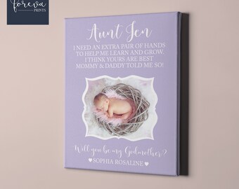 May include: A lavender canvas print with the text "Aunt Jen" and a message asking someone to be a godmother. The print also includes a photo of a baby girl sleeping in a nest.