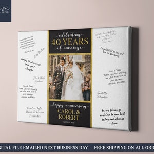 Könnte beinhalten: Ein weißer Leinwanddruck mit schwarzem und goldenem Rand, der einen 40. Hochzeitstag feiert. Der Druck zeigt ein Foto eines Paares an ihrem Hochzeitstag, umgeben von Konfetti. Der Text "40 Jahre Ehe feiern" ist in goldenen Buchstaben auf schwarzem Hintergrund geschrieben. Die Namen "Carol & Robert" sind in goldenen Buchstaben auf schwarzem Hintergrund geschrieben. Das Datum "12. April 2023" ist in goldenen Buchstaben auf schwarzem Hintergrund geschrieben. Der Druck enthält auch handgeschriebene Botschaften von Gratulanten.