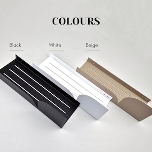May include: Three wall shelves in black, white, and beige. Each shelf has a curved edge and a series of parallel lines.