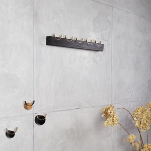 Modern wall mounted coat peg rails for clothes.