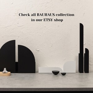 May include: Black geometric shapes made of metal, arranged in a modern design. The shapes are on a white surface with the text "Check all BAUHAUS collection in our ETSY shop".