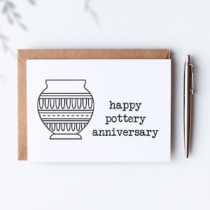 May include: A white card with a black line drawing of a pottery vase and the text "happy pottery anniversary".