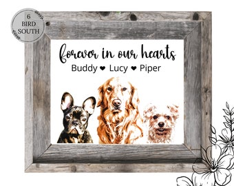 May include: A framed print with a white background and three dog portraits. The text "forever in our hearts" is above the portraits, and the names "Buddy", "Lucy", and "Piper" are below the portraits. The frame is made of rustic wood.