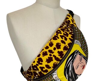 May include: Yellow, brown, and green fanny pack with a leopard print, a black and white illustration of a woman's face, and the text "See The" on the front.