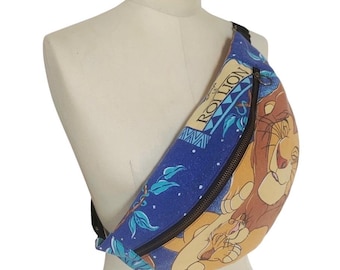May include: A blue fanny pack with a black zipper and strap. The pack features a design with the text "ROLLION" and an illustration of characters from The Lion King. The pack is displayed on a mannequin.