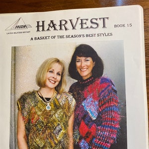 May include: Two women are wearing colorful knitted sweaters. The woman on the left is wearing a multi-colored sweater with a brown vest over it. The woman on the right is wearing a red, blue, and white striped sweater. The image is from a book called "Harvest, A Basket of the Season's Best Styles, Book 15" by Laura Miltizer Bryant.