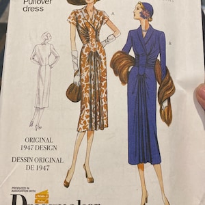 May include: Vintage Vogue pattern for a pullover dress, featuring illustrations of two different dress designs. The pattern includes the text "Original 1947 Design" and "Dressmaker". The size range is E5 (14-16-18-20-22).