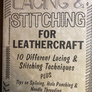 May include: A book titled "LACING & STITCHING FOR LEATHERCRAFT" with text detailing 10 different lacing and stitching techniques, plus tips on splicing, hole punching, and needle threading. The cover is beige with black text and decorative borders.