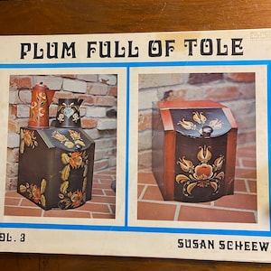 May include: A vintage book cover with the title "Plum Full of Tole" and a photo of two painted wooden boxes with floral designs. The book is by Susan Scheewe.