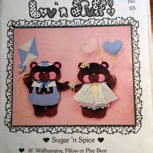 May include: Sewing pattern for two teddy bears, one in blue and white and one in pink and white, with the title "Sugar 'n Spice" and the text "16" Wallhanging, Pillow or Play Bear Fun 'n Easy-to-Make Sew Beary Sweet!!"