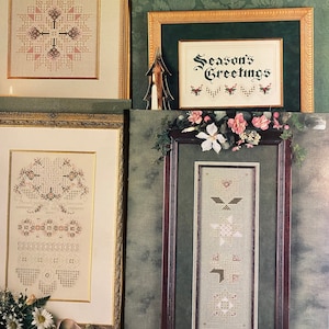 May include: Four framed cross stitch patterns with a green background. The patterns are titled "Season's Greetings", "Dreams", "Another Story", and "Season's Greetings".