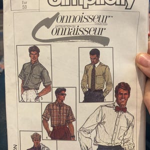 May include: Simplicity Connoisseur Collection sewing pattern. The pattern features illustrations of men's shirts in various styles. The pattern includes sizes 40 and Eur 50. The pattern number is 7015.