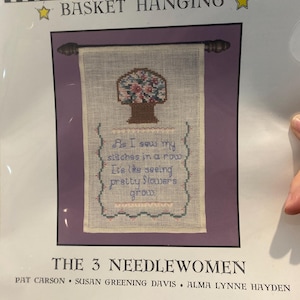 May include: A white ceramic mug with a black handle and the text "But First, Coffee" in a black, bold font. The mug is on a white surface.