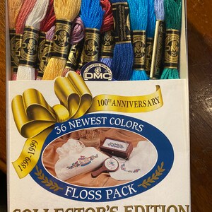 May include: A box of 36 skeins of DMC embroidery floss in a variety of colors. The box is labeled "Collector's Edition" and features a 100th Anniversary logo. The floss is 8.7 yards per skein.