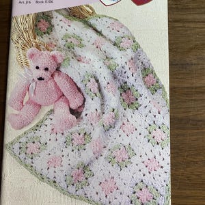 May include: A softcover instructional booklet titled Quick Knit and Crochet Projects Fast & Fun Art J16 Book 0106. The cover features a pink teddy bear with a white ribbon and a white, pink, and green crocheted blanket with a square pattern.